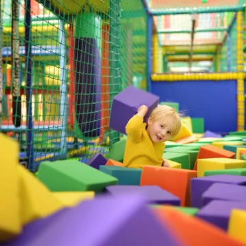 A child playing in a Soft Play area