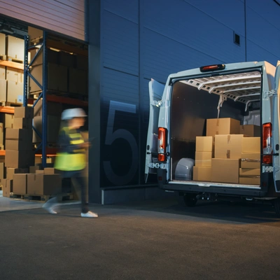 Warehouse Employees Loading A Van With Contents