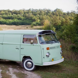 Green Campervan Parked Along A Field Path