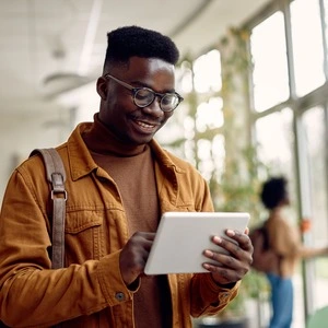 A university student holding their tablet