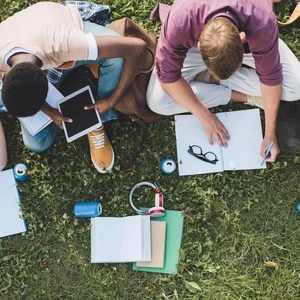 Students studying while surrounded by various gadgets