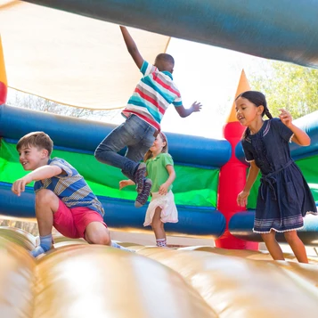 Children playing in a bouncy castle