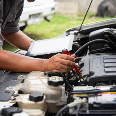 A Motor Trade Working On A Car From Home